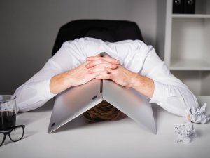 Man laptop over head despair CR iStock