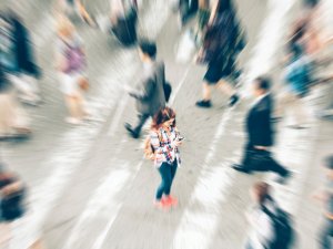 Woman in a crowd, mobile phone