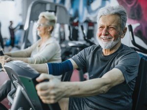 Older man exercising, exercise bike, elder health