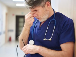 Tired doctor CR gpointstudio on iStock