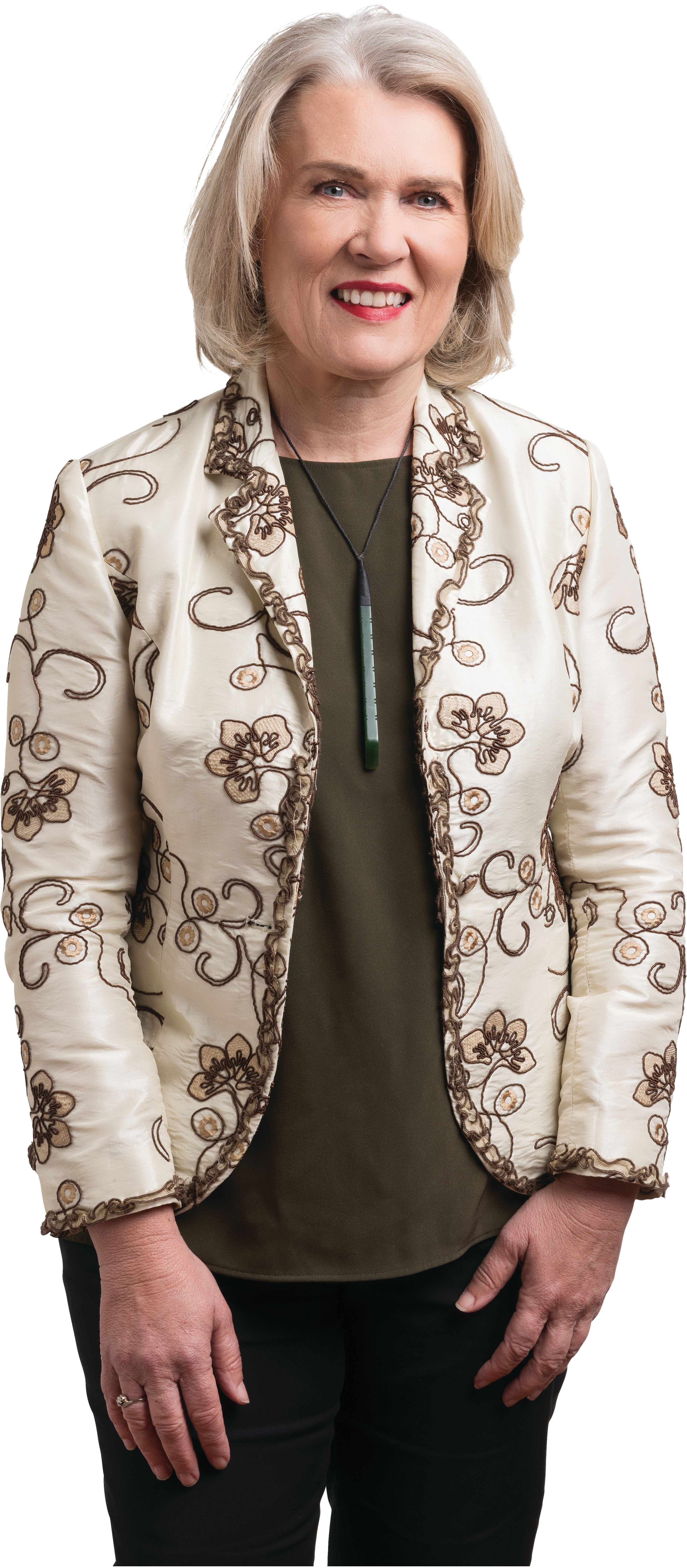 Woman with blonde hair, olive green top and a cream patterned blazer